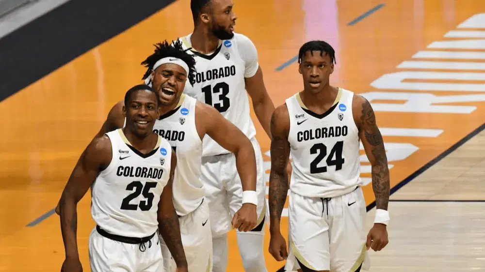 Mar 20, 2021; Indianapolis, Indiana, USA; Colorado Buffaloes guard McKinley Wright IV (25) celebrates with forward Evan Battey (21) after making a basket against the Georgetown Hoyas during the first round of the 2021 NCAA Tournament at Hinkle Fieldhouse. Mandatory Credit: Patrick Gorski-USA TODAY Sports