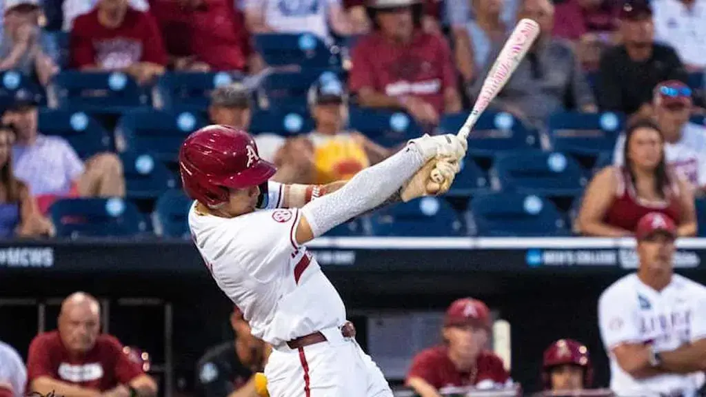 An Arkansas baseball player swings during the 2025 College World Series (Arkansas vs. Murray State CWS 6/16/2025 Prediction & Picks cover)