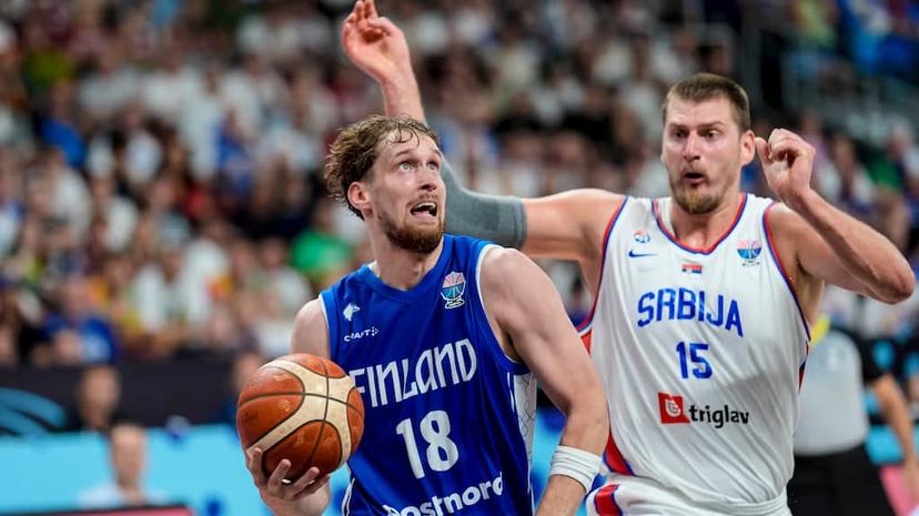 Finland basketball player Mikael Jantunen (left) goes up against Serbia's Nikola Jokic (right)