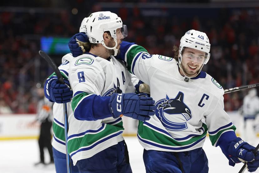 Quinn Hughes and teammate